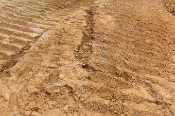 Yellow sunken wheel mark on dirt road