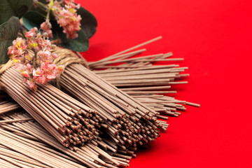 Dried Organic Buckwheat Soba Noodles Ready to Cook on red background  - Image