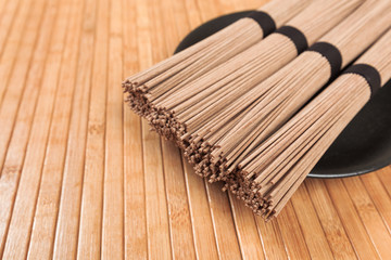 Buckwheat noodles closeup. Raw food ingredient. Dried buckwheat soba noodles. Traditional Japanese food - Image