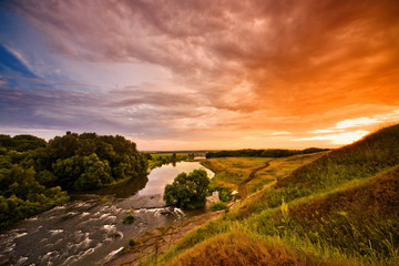 Magnificent sunset overlooking the river and forest
