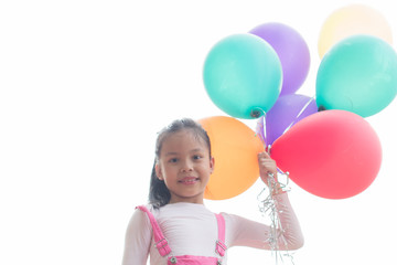 happy little asian girl child playing with colorful toy balloons outdoors. summer holidays, celebration, family, children and people-happy girl with colorful balloons. freedom and imagination concept.