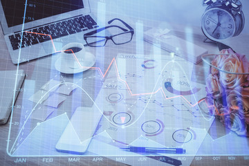 Financial market graph hologram and personal computer on background. Multi exposure. Concept of forex.