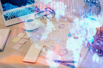 Financial chart drawing and table with computer on background. Multi exposure. Concept of international markets.