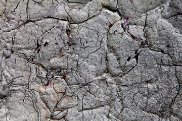 Surface texture with white paint and cracks on concrete wall with strong surface structure. For abstract backgrounds.