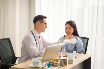 Asian Doctor and patient talking and checking  health care medicall sickness at hospital