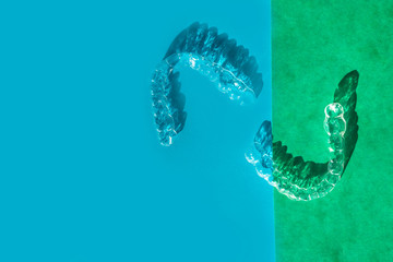 Invisible aligners teeth brackets on blue background