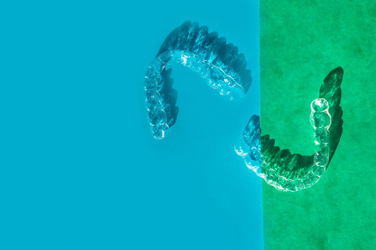 Invisible aligners teeth brackets on blue background