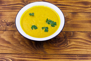 Pumpkin soup on a wooden table