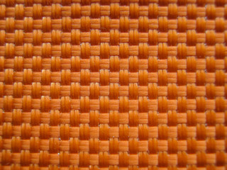 Abstract fabric background with interlacing fibers and threads. Orange fabric texture background. The original background.