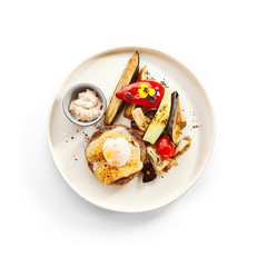 Steak with sous vide egg and baked vegetables