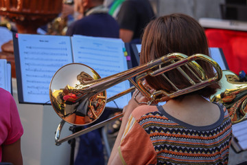 Woman playing the trombone in an orchestra