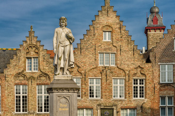 Fototapeta na wymiar Statue of the Flemish painter Jan van Eyck in Bruges, Belgium