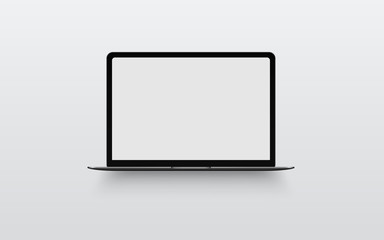 Space gray laptop with blank computer screen on gray background. Front view notebook mock up. The...