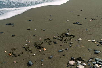 Fototapeta na wymiar Word Cyprus written on beach sand