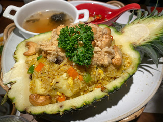  Freshly prepared pineapple fried rice served inside of a pineapple carved like a bowl.