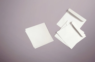 White envelope and post card on background. Top view blank envelope mockup and blank letterhead...