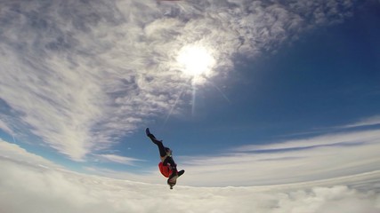 Artistic. Parachutist performs an acrobatic trick in the air. Flying men make professional jump. Extreme as a hobby. 