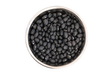 Dried Black Beans from above in a stainless steel bowl, isolated on a white background. Healthy ingredient used in soups and casseroles. Naturally preserved legumes with long shelf life.