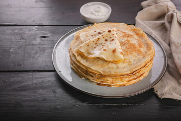 A stack of pancakes on a plate. Slavic national holiday Maslenitsa. Copy space