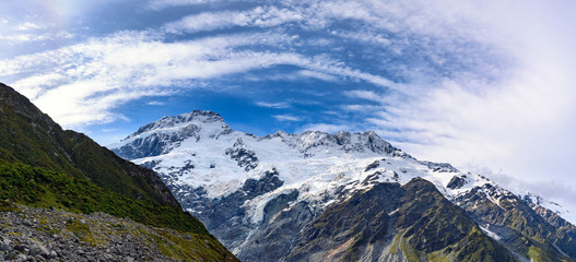 Panorama view the mueller glacier at kea point in Mount Cook National Park, the rocky mountains and green grasses of summer in New Zealand.