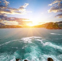 Ocean wave crashing on rock in the bay