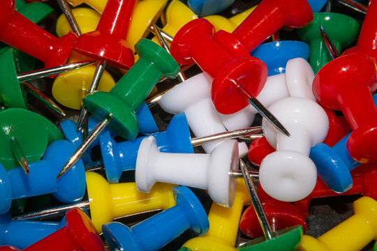 a freely arranged and colorful photo of a thumtack.