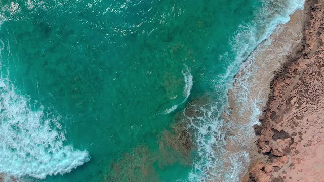 waves on beach, areal view waves break on stony coast, beach with rocks