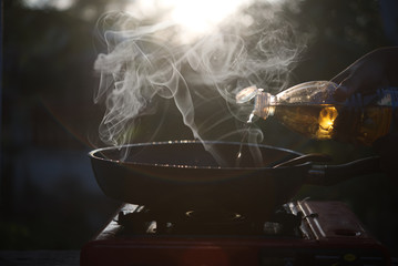 Cooking with smoke and sunset light background.