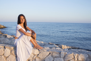 Woman in white dress on the beach