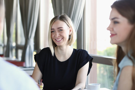 Group Of People Solves The Problem In The Course Of A Conversation Sitting At A Table In A Cafe Denigrate Education Teaching Each Other Questions And Answers Training