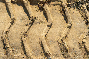 Closeup tire tractor tracks on dirt road 