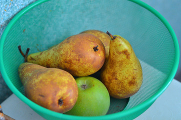 pears and apples in a basket on the kitchen table