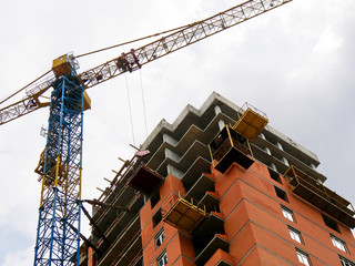 Construction site with crane and building. Crane and building under construction.