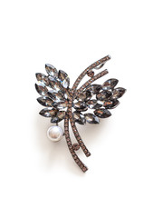 Metal brooch with stones and a pearl on a white background