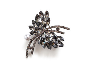 Metal brooch with stones and a pearl