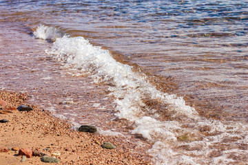 soft focus sand stone ground coast line sea side beach with water waves fuzzy surface outdoor scenic background