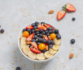 Breakfast smoothie bowl with berries, fruit, nuts and muesli.