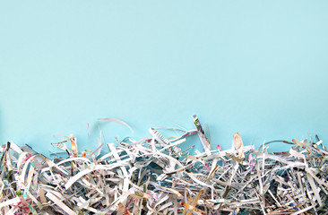 Shredded paper on light blue background. Selective focus image.