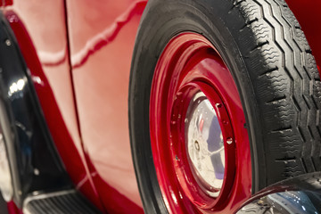 fragment of the side of an old red car with