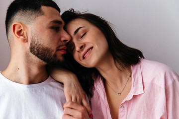 sexy couple at home. Woman in lingerie kissing, hugging and playing with her husband