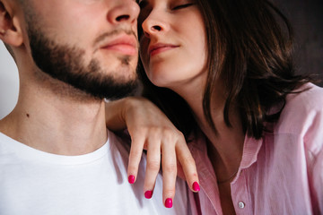 sexy couple at home. Woman in lingerie kissing, hugging and playing with her husband