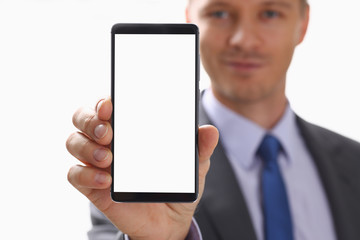 A businessman holds a new smartphone in his hand The mobile application market shows a display you can insert your image for advertising or financial statistics