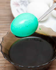 Painting eggs in the kitchen.