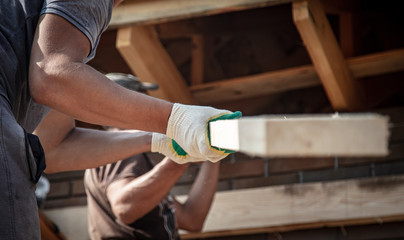 Worker holds a wooden board.