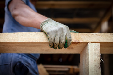 Worker holds a wooden board.