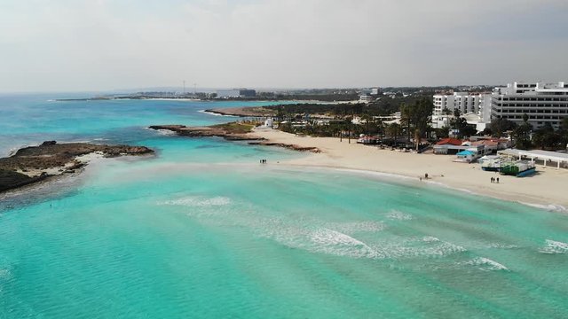 Drone view of sea with beach and hotel resorts in Aya Napa city, Cyprus