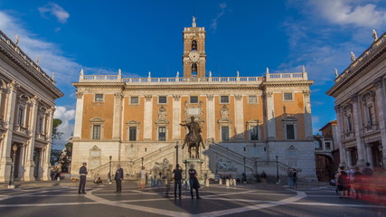 Fototapeta na wymiar Capitoline hill landmark square timelapse surrounded by neo classic museums buildings with clock tower and bronze statue of Mark Aurelius
