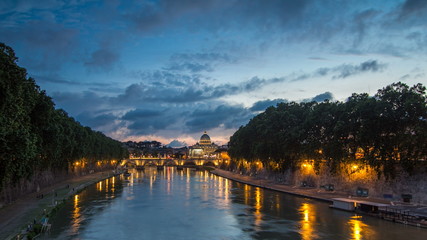 Fototapeta premium Rome, Italy: St. Peter's Basilica, Saint Angelo Bridge and Tiber River after the sunset day to night timelapse