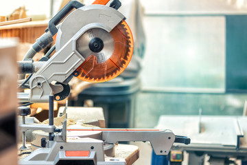 Professional compound mitre circular saw at emnty woodcraft carpentry workshop. DIY carpenter...