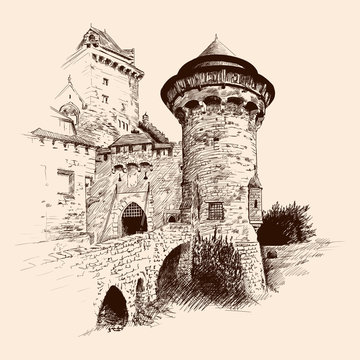 Medieval stone castle with towers by the sea and a bridge.
